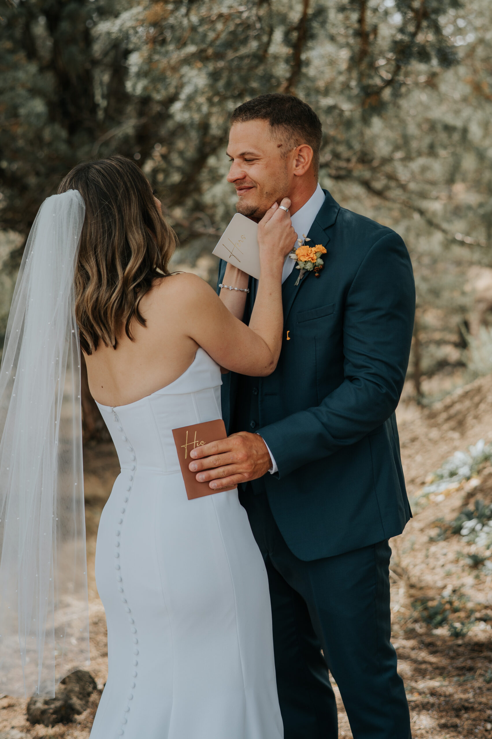 bride in white dress embracing groom outdoor at their first look